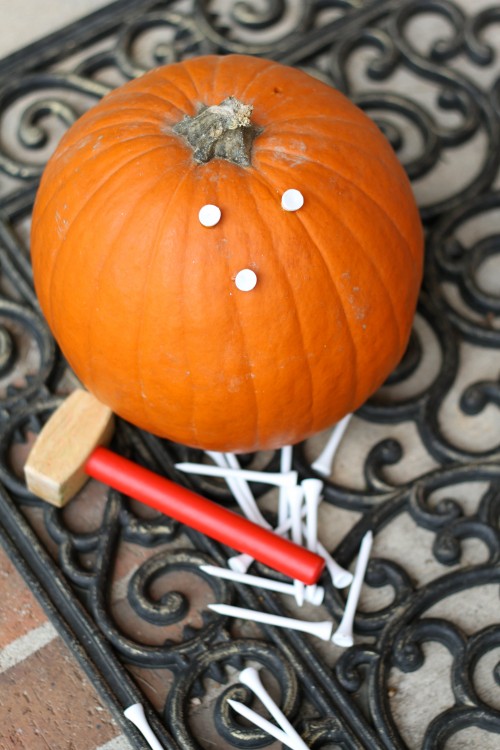 Pounding Golf Tees into a Pumpkin