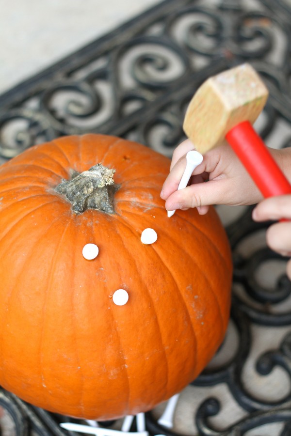 Pounding Golf Tees into a Pumpkin